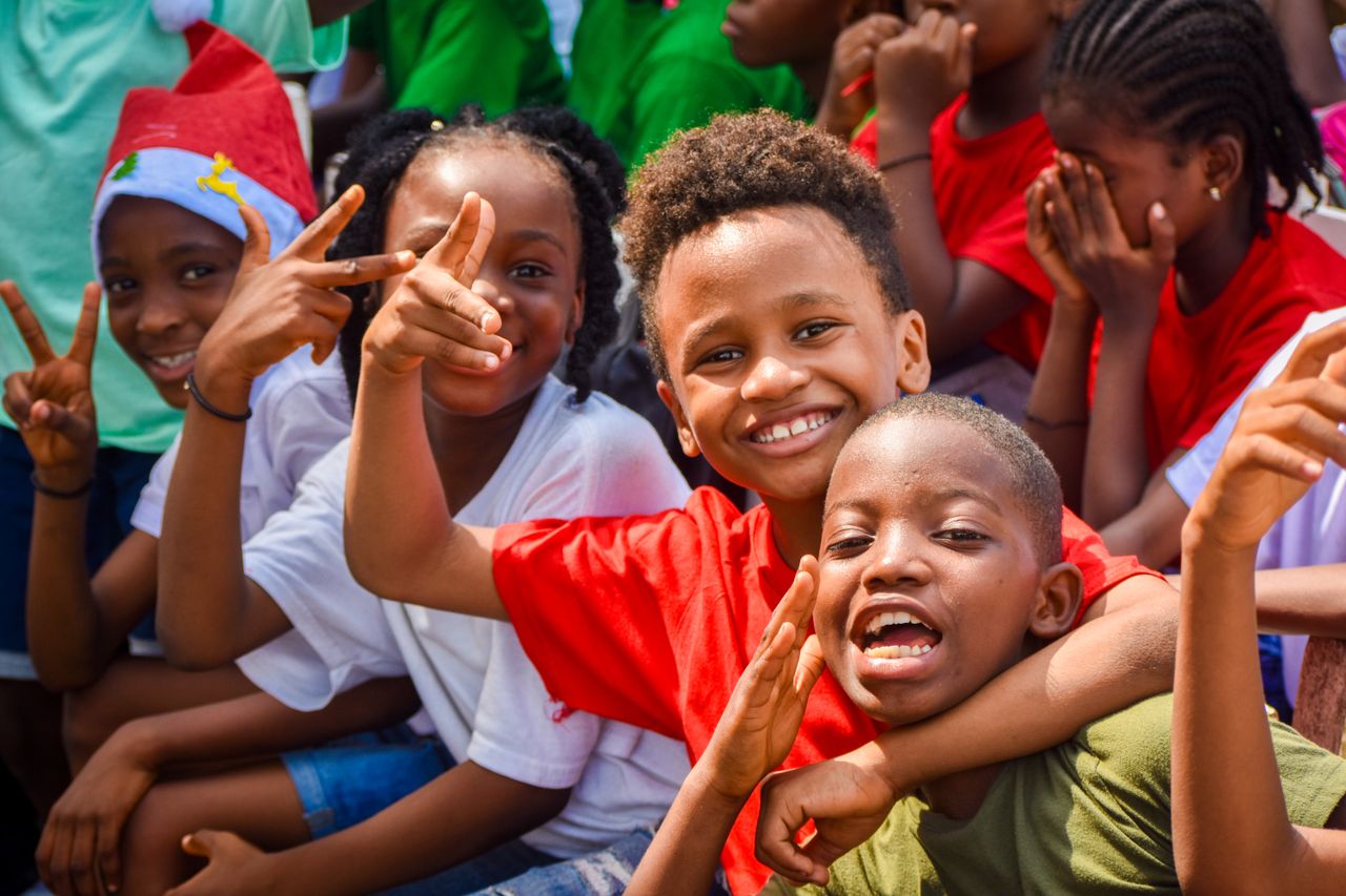 Group of happy children enjoying an outdoor play activity in Monrovia, Liberia.